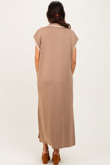 woman wearing a long brown maxi dress with short sleeves and a delicate lace trim on the neckline
