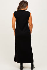 woman wearing a long black sleeveless maternity dress, seen from the back