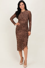 woman wearing a brown leopard print long sleeve midi dress with a side ruching detail