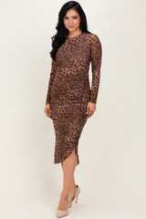 woman wearing a brown leopard print long sleeve midi dress with side ruching and a high slit