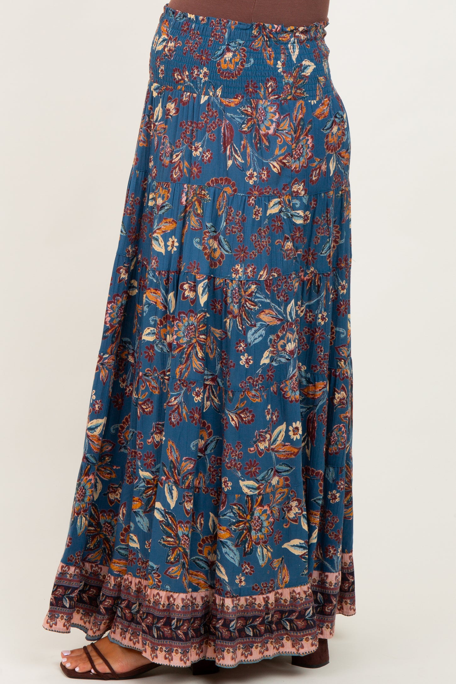 maternity wear blue floral maxi skirt with smocked waistband and tiered design, model shown from the side