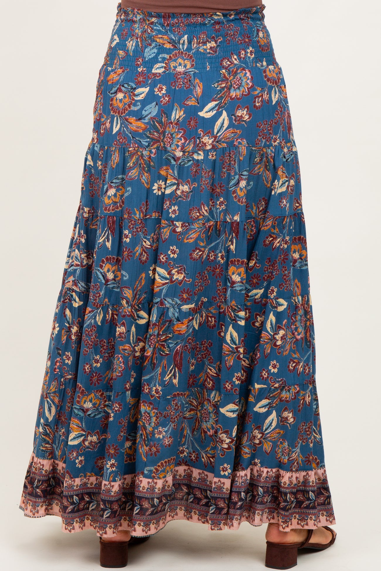 maternity wear blue floral maxi skirt with smocked waist and tiered design, back view, model not visible