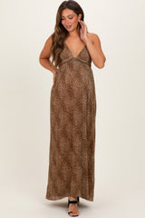 woman wearing a brown leopard print maternity maxi dress with a v-neckline and adjustable straps, showing her baby bump