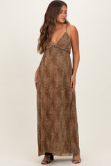 woman wearing a brown leopard print maxi maternity dress with a front zipper and adjustable straps, showing her baby bump