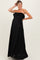 woman wearing a black strapless pleated maternity dress with ruffle detailing and a visible baby bump