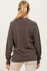 woman wearing a dark brown maternity sweatshirt with a relaxed fit, seen from the back