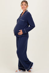 woman wearing a navy blue maternity pajama set with long sleeves and pants, showing her baby bump