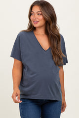 woman wearing a navy blue short sleeve maternity top with a v-neck and baby bump visible
