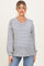 woman wearing a striped maternity sweater with a v-neckline and long sleeves, paired with blue jeans