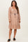 woman wearing a blush pink floral maternity dress with long sleeves and a drawstring waist, showing her baby bump