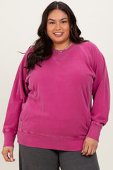woman wearing a vibrant pink plus size v-neck sweatshirt with long sleeves and relaxed fit
