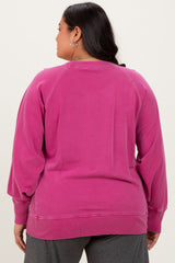 woman wearing a pink plus size sweatshirt with a relaxed fit and ribbed hem, showing the back view