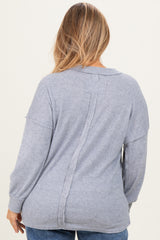 woman wearing a light gray ribbed maternity sweater featuring a back seam detail