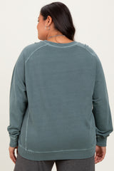 woman wearing a back view of a teal oversized sweatshirt with long sleeves and ribbed hem in plus size