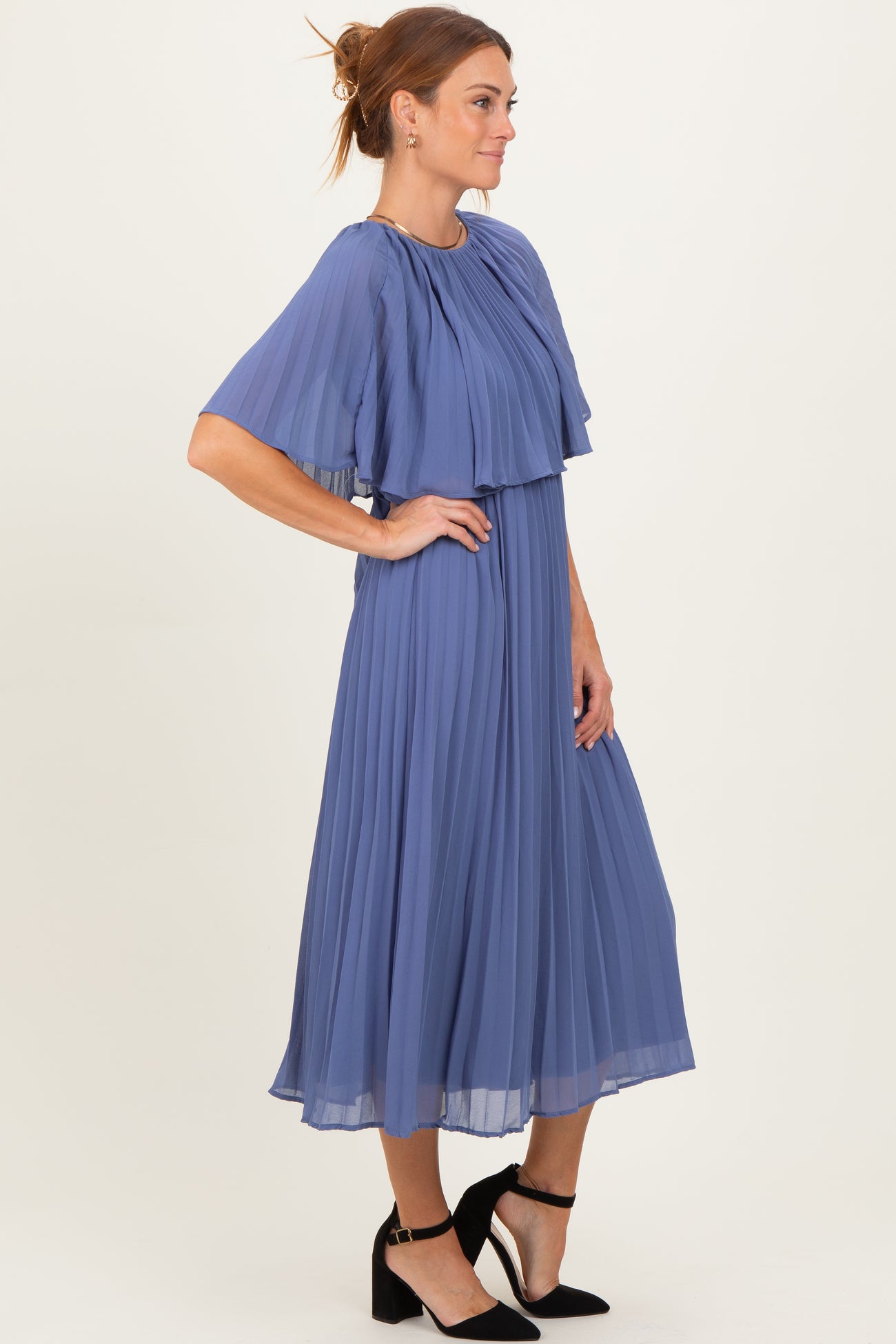 woman wearing a pleated lavender midi dress with flutter sleeves and a flowy silhouette
