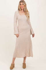 woman wearing a beige long sleeve ribbed maxi dress with a square neckline and flared sleeves