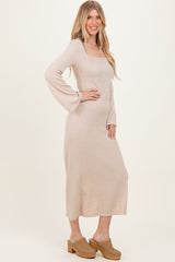 woman wearing a beige ribbed long sleeve maxi dress and tan clogs