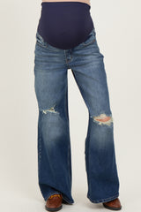 maternity wear dark blue belly support flared jeans with distressed details, worn by a model showcasing a baby bump