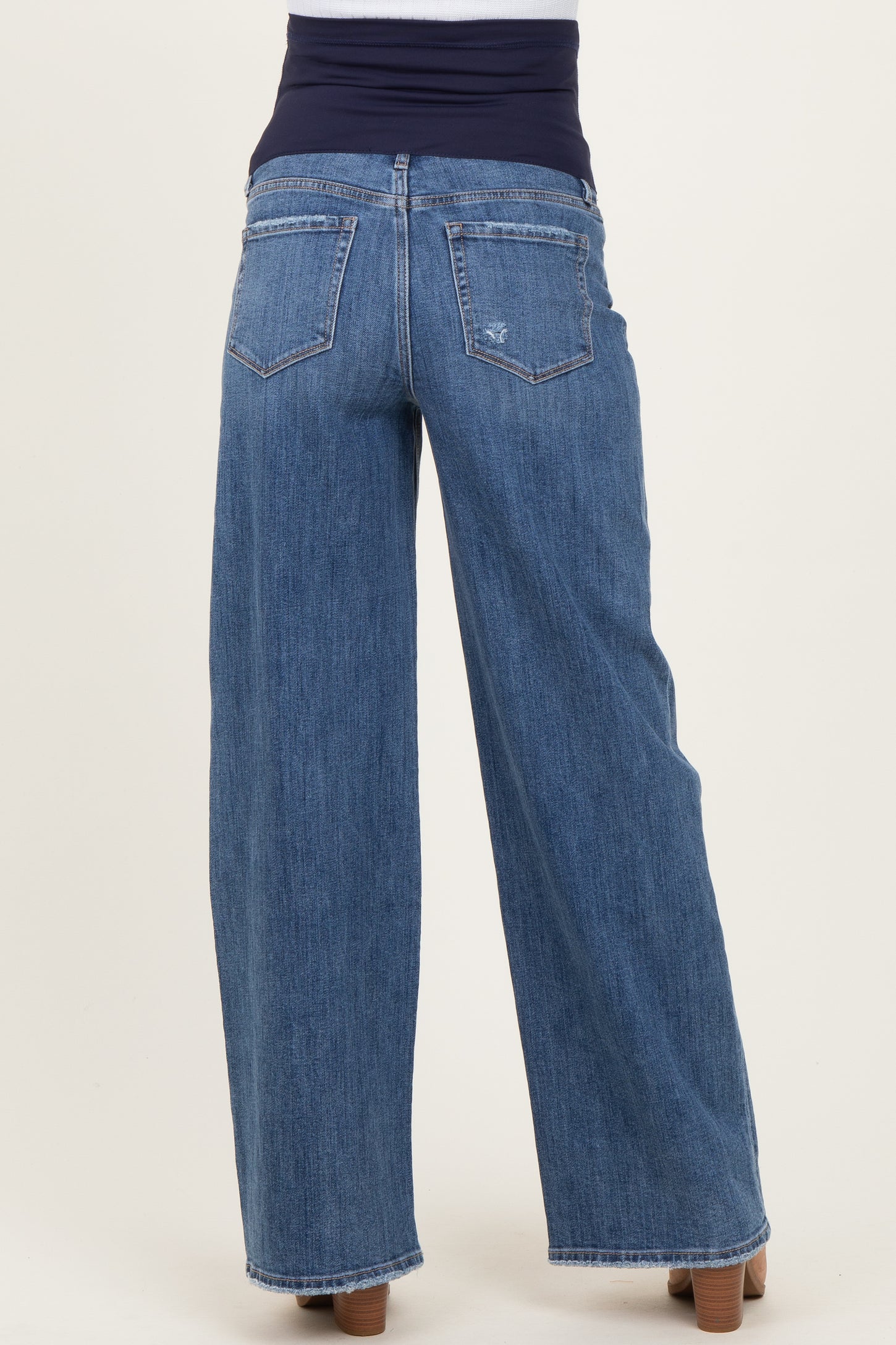 woman wearing dark blue wide-leg maternity jeans with a stretchy waistband, viewed from the back