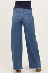 woman wearing dark blue wide-leg maternity jeans with a stretchy waistband, viewed from the back