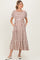 woman wearing a brown and white striped maternity maxi dress with short puff sleeves and pockets