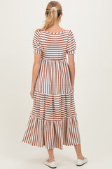 woman wearing a striped maternity dress with short puff sleeves and a tiered skirt, showing the back view