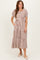 woman wearing a striped tiered midi dress with puff sleeves and pockets in neutral tones