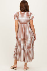woman wearing a light brown and white striped tiered maxi dress with short sleeves and a relaxed fit