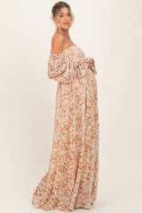 woman wearing a floral off-the-shoulder maternity maxi dress showing her baby bump