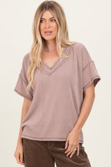 woman wearing a mauve striped short sleeve v-neck top with a relaxed fit