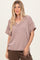 woman wearing a mauve striped short sleeve v-neck top with a relaxed fit