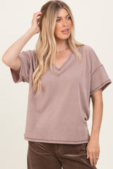 woman wearing a mauve ribbed v-neck short sleeve top with relaxed fit