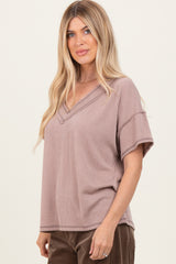 woman wearing a taupe ribbed v-neck short sleeve top