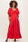 woman wearing a red maternity maxi dress with flutter sleeves and a drawstring neckline, holding her baby bump
