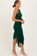 woman wearing a green one-shoulder ruched dress with a high-low hem and ruffle details