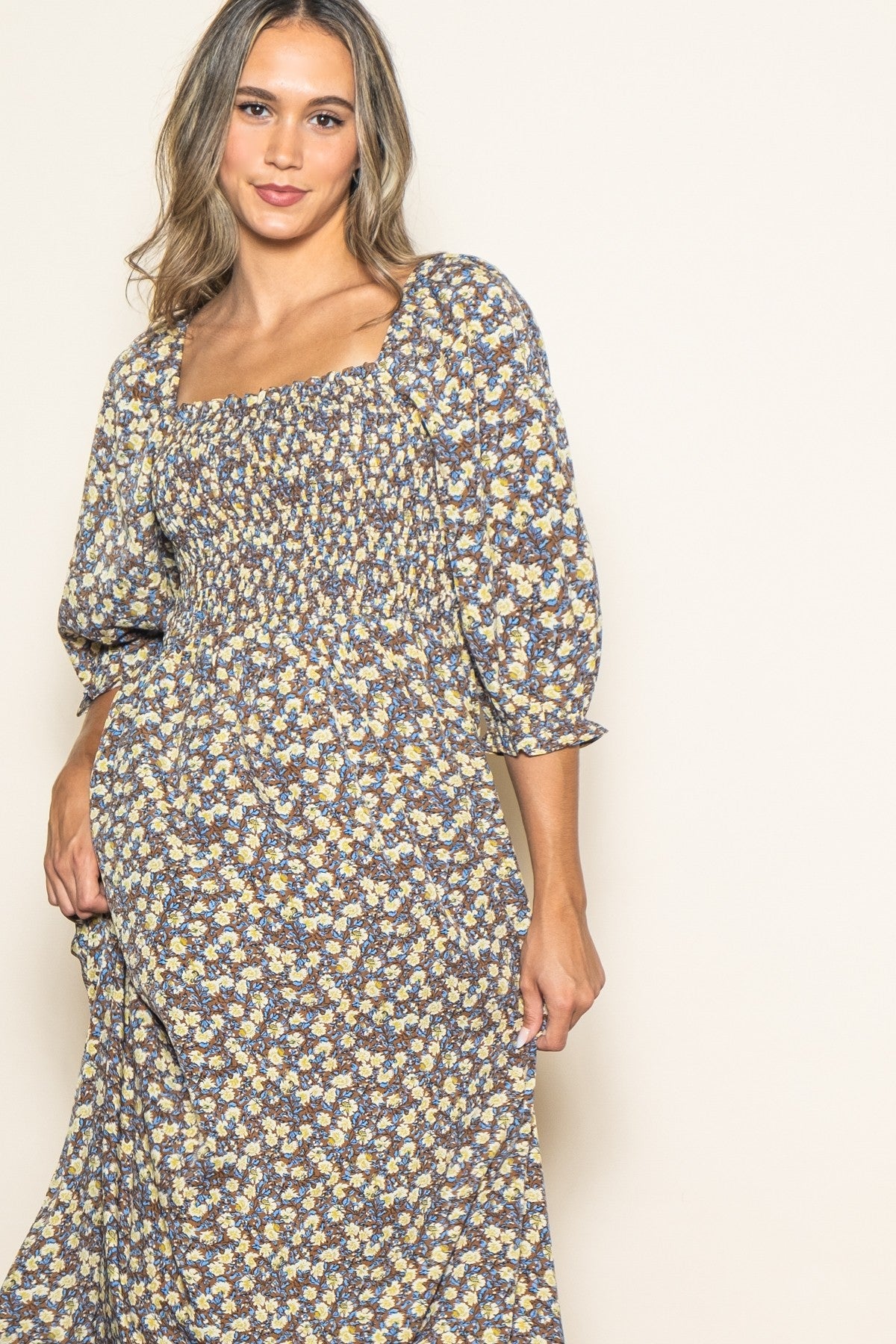 woman wearing a floral print maxi dress with a square neckline and puff sleeves