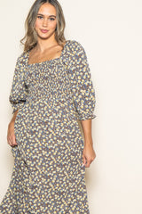 woman wearing a floral print maxi dress with a square neckline and puff sleeves