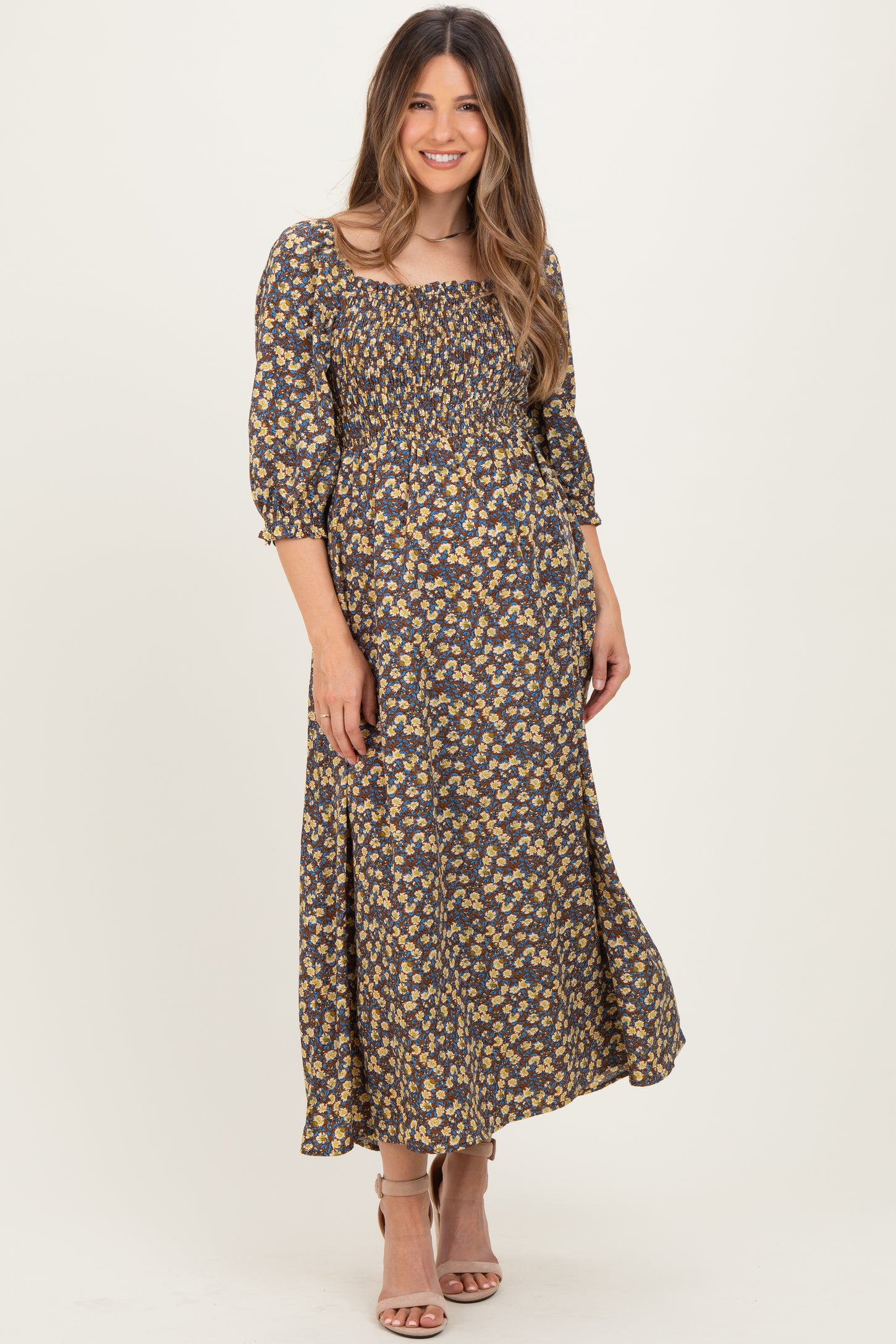 woman wearing a navy floral maternity maxi dress with a square neckline and three-quarter sleeves