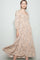 woman wearing a beige floral tiered maxi dress with long sleeves and a square neckline