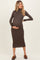 woman wearing a brown long sleeve maternity dress, highlighting her baby bump