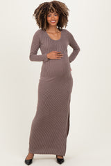 woman wearing a brown ribbed maternity maxi dress and holding her baby bump