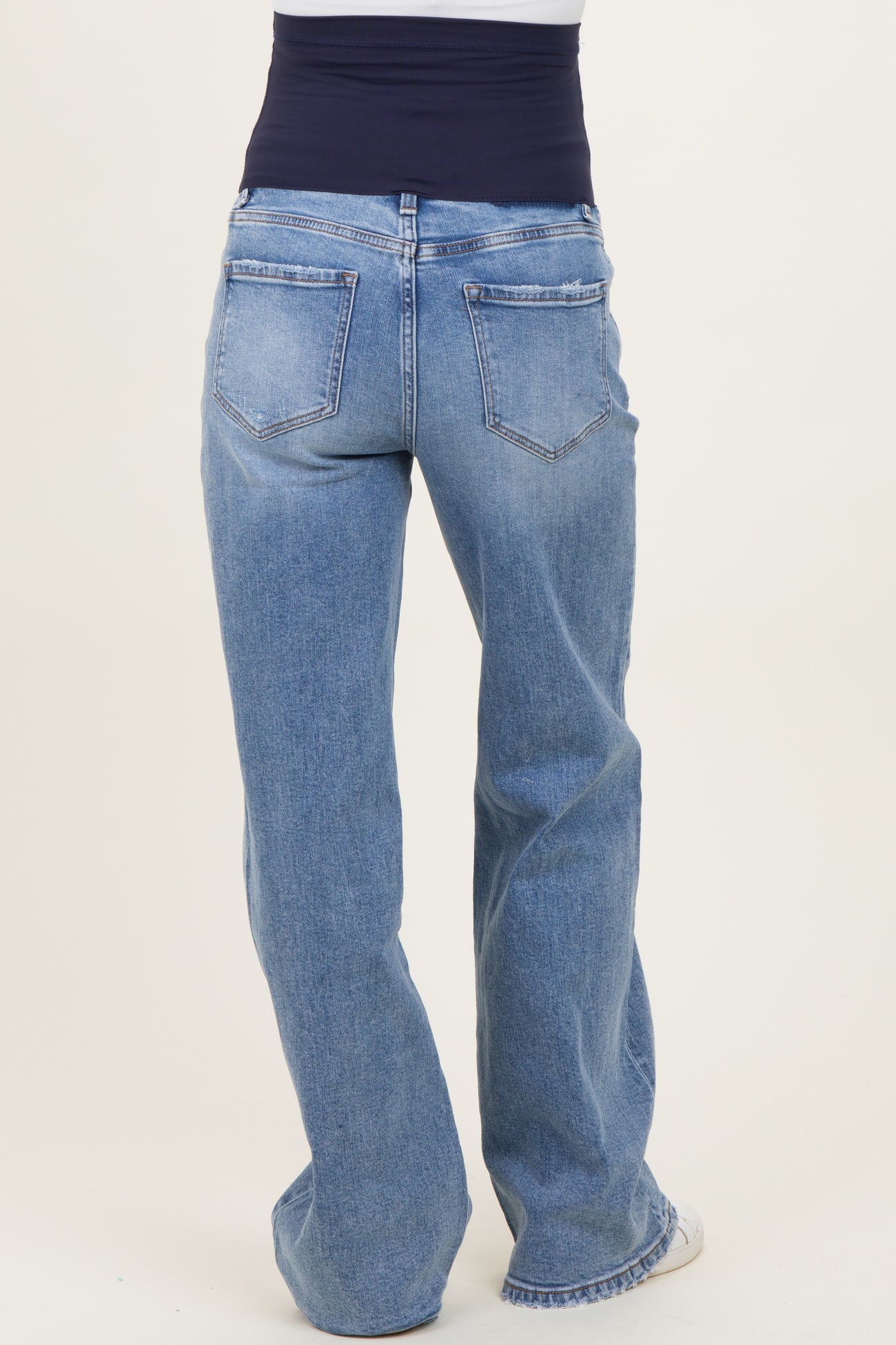 maternity wear light blue wide-leg jeans with a navy blue waistband, shown from the back