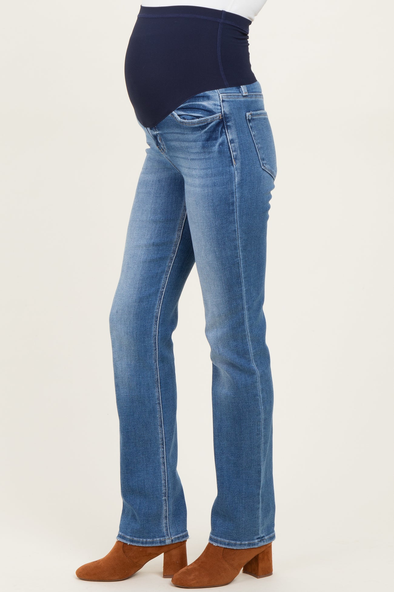 maternity wear light blue over-the-bump jeans with a fitted waist and straight leg, showcasing a visible baby bump