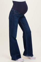 woman wearing dark blue maternity jeans with a supportive belly panel and a visible baby bump