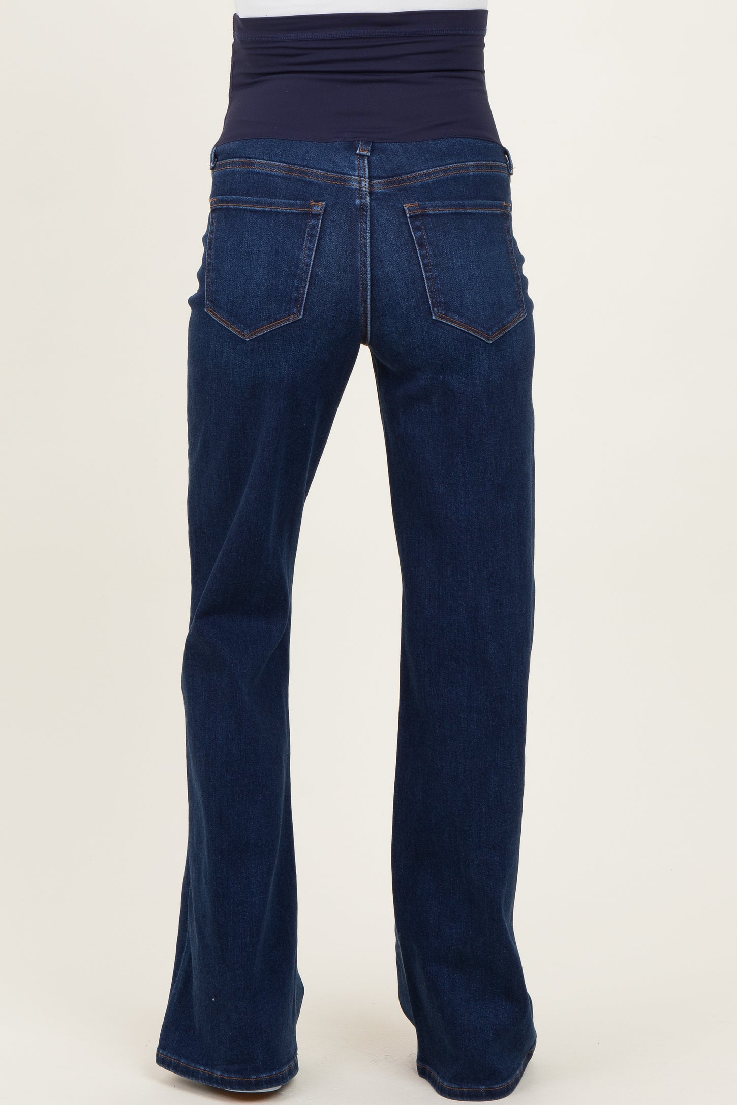 maternity wear dark blue flared jeans with a stretchy navy waistband, shown from the back