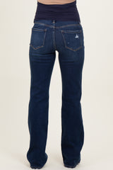 woman wearing dark blue maternity jeans, shown from the back with a fitted band at the waist