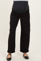 woman wearing black maternity pants with a stretchy belly panel and rolled cuffs