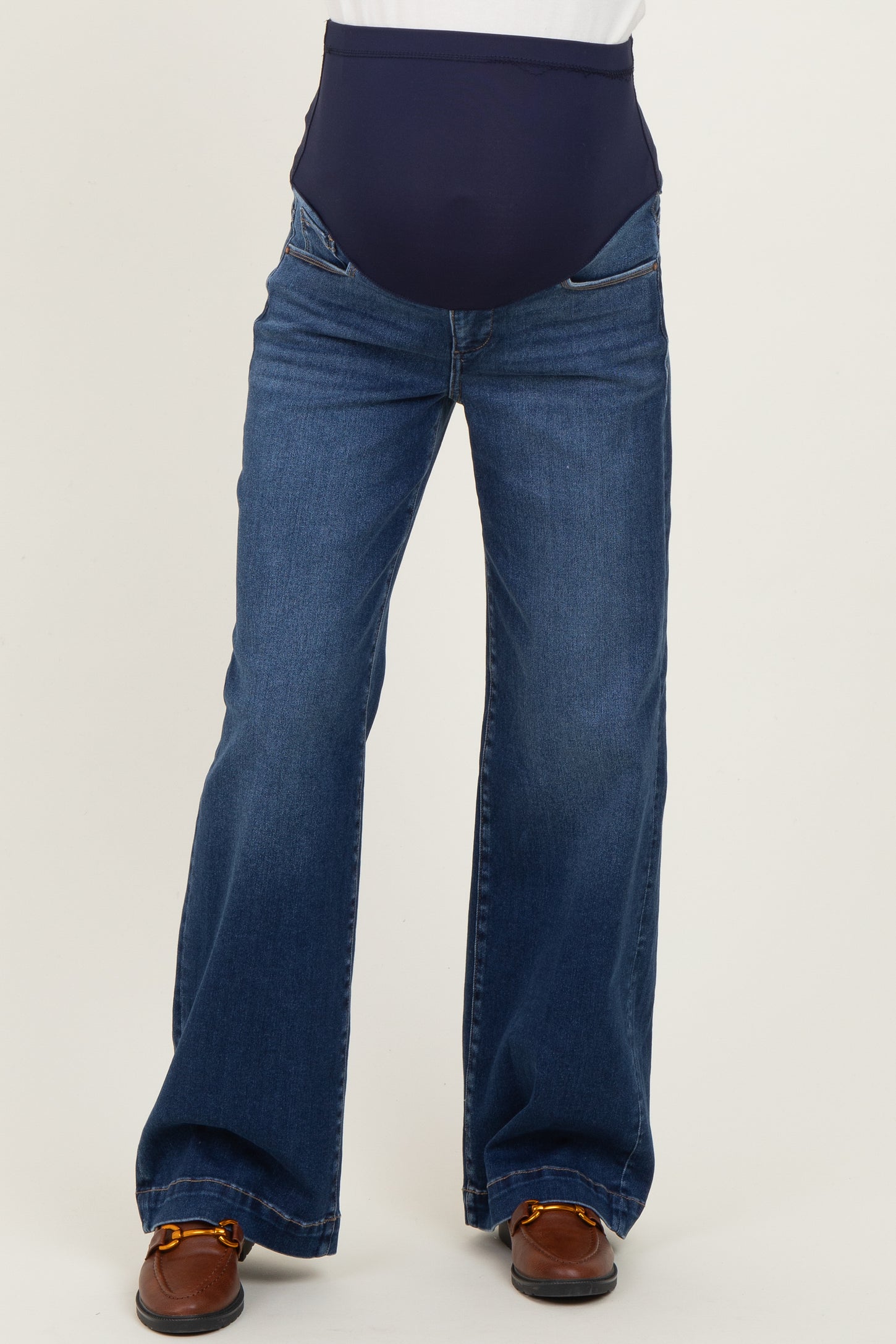 woman wearing dark blue maternity jeans with a wide-leg style and a supportive belly band