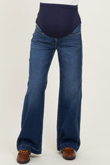 woman wearing dark blue maternity jeans with a wide-leg style and a supportive belly band