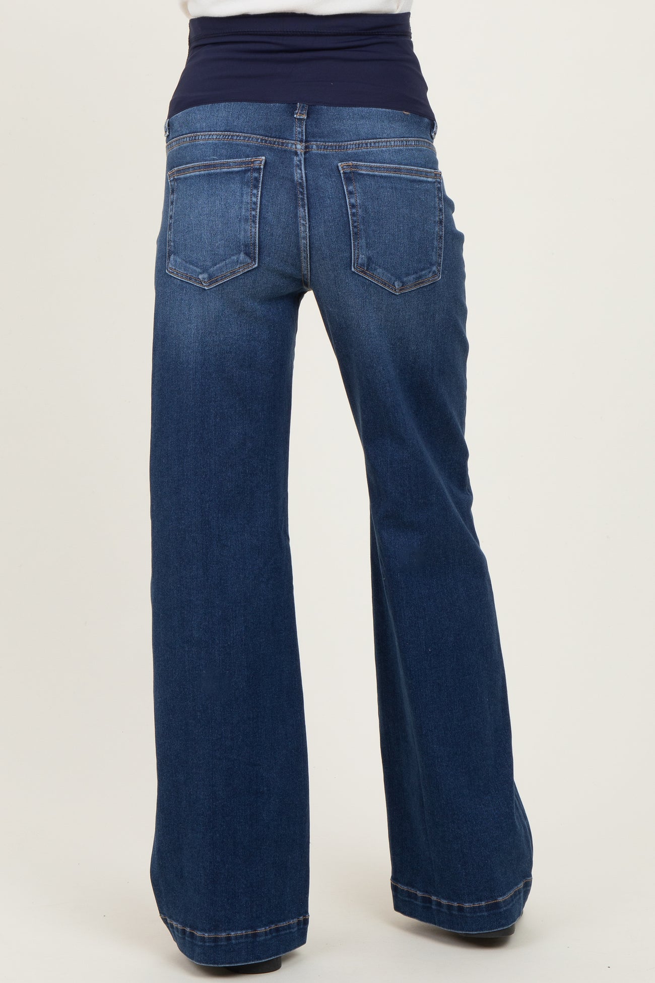 woman wearing dark blue maternity wide-leg jeans with a stretchy waistband, viewed from the back